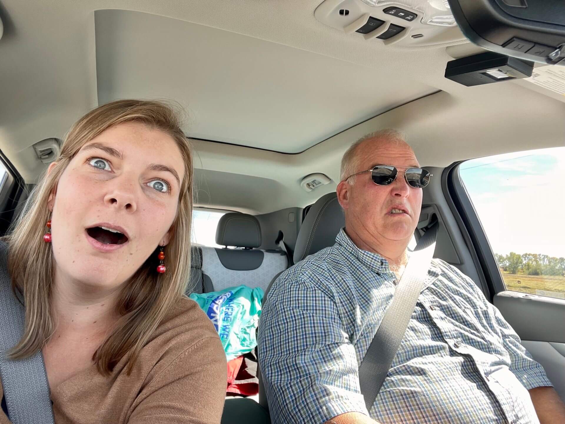 Celest and Rick are in a vehicle. Celeste looks worried. Rick looks disgusted.