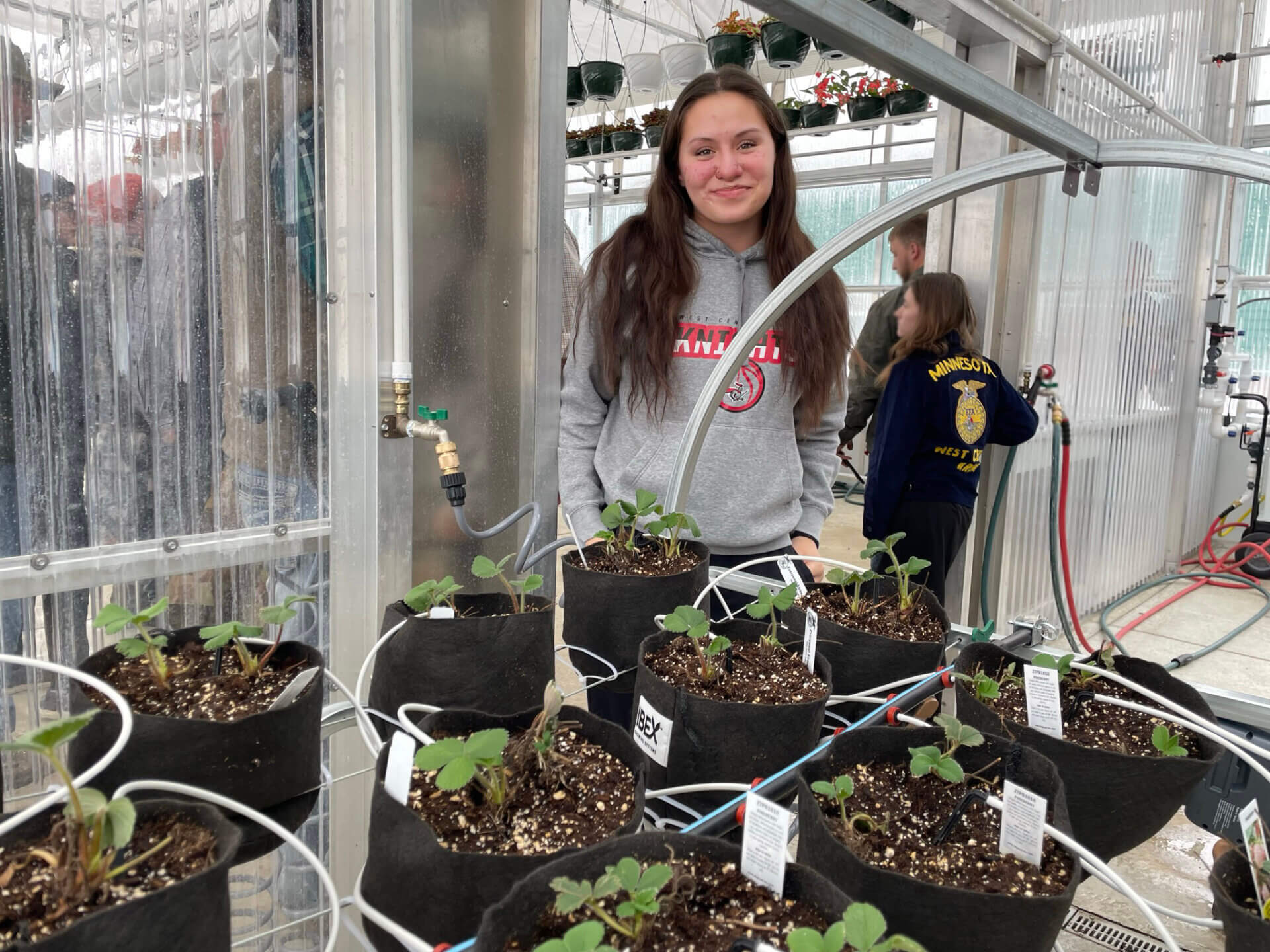Student & Borlaug Scholar Mylee Vocu presented strawberry seedlings during the greenhouse tours during the open house celebration on February 21.