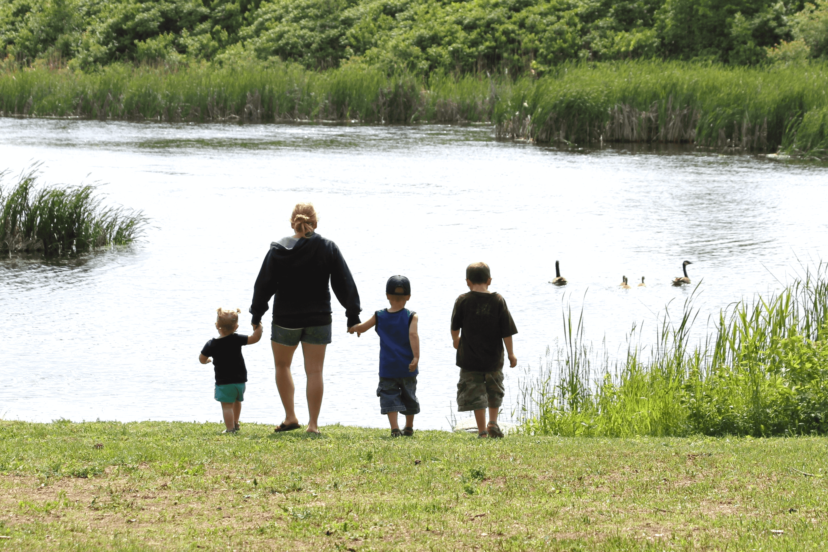  Family at shore of Otter Tail River on Tamarac Refuge