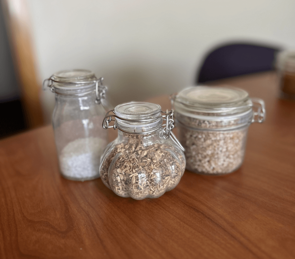 three jars of different materials. Left, resin; center, biomass; and right, pellets.
