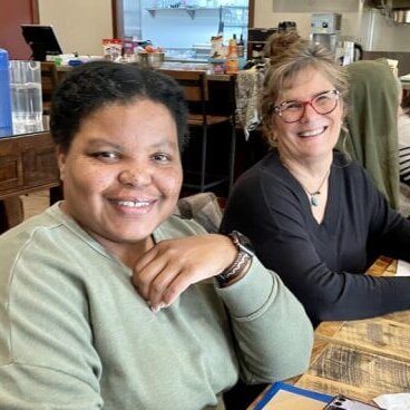 Two women smiling,