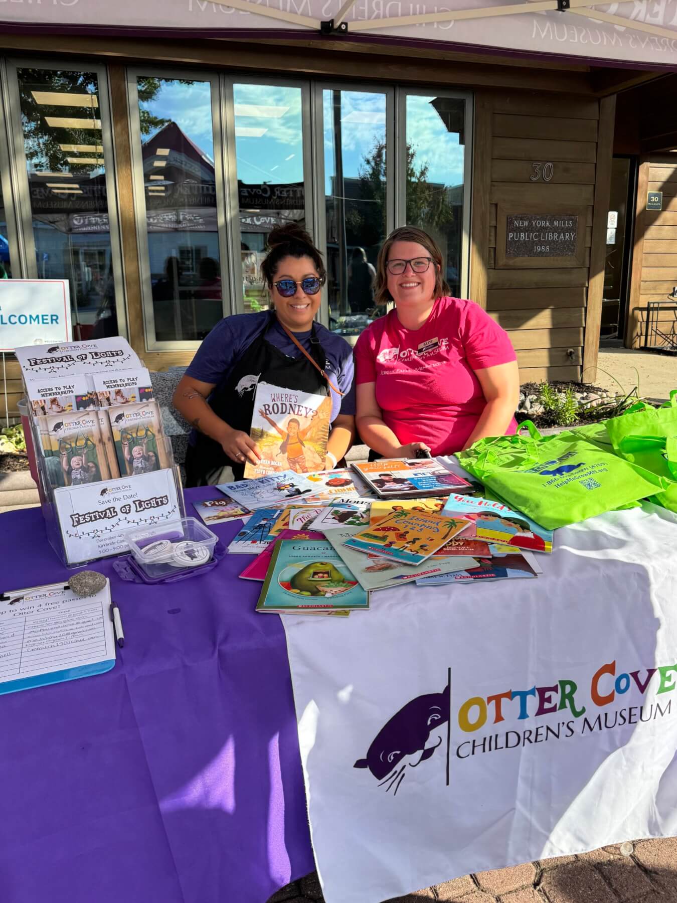 Katie Ganoe and Amara Erickson at the Otter Cove booth during a festival.