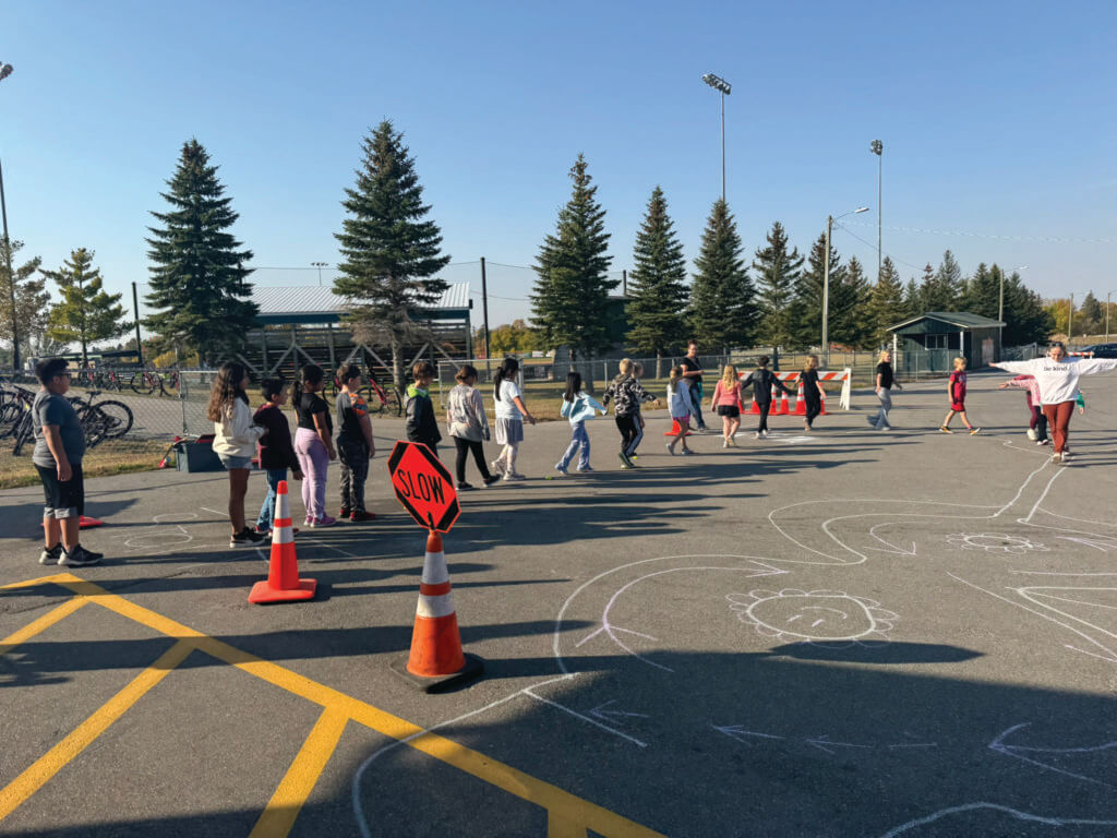 WCI employee leads group of kids through obstacle course.